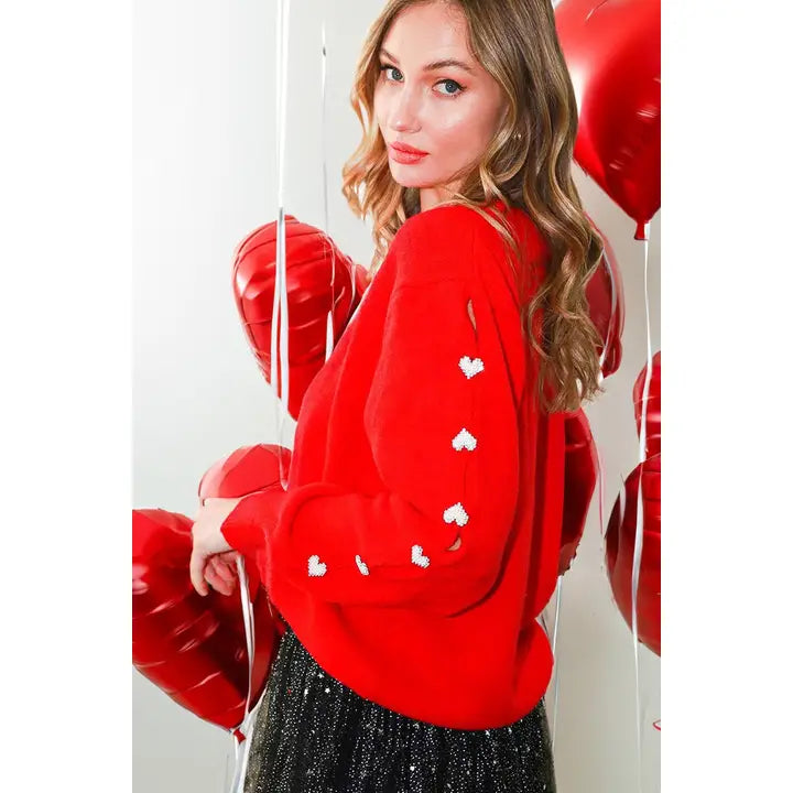 Weekend Offers That Sizzle Red sweater with hearts on sleeve